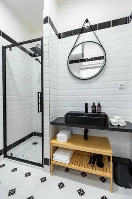 a bathroom with a black sink and a shower at Residence I at Havel's Market in Prague