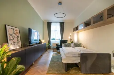 a living room with a couch and a tv at Residence I at Havel's Market in Prague