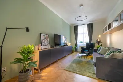 a living room with a couch and a tv at Residence I at Havel's Market in Prague