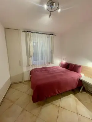 a bedroom with a red bed and a window at Jakub's home in Prague