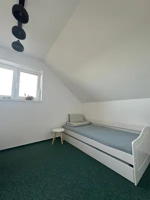 a white room with a bed and a window at Chata Mšené-lázně - Vrbice in Loucká