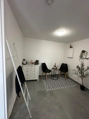 a room with two chairs and a dresser and a desk at Chata Mšené-lázně - Vrbice in Loucká