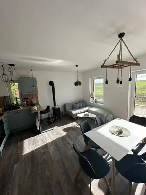 a living room with a table and chairs and a couch at Chata Mšené-lázně - Vrbice in Loucká