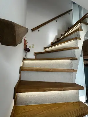a staircase in a house with wooden treads at Chata Mšené-lázně - Vrbice in Loucká