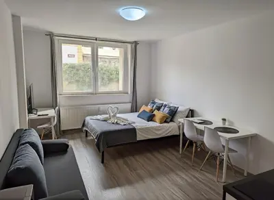 a bedroom with a bed and a table and a couch at NEW beautiful apartment 15 minutes from the city center in Prague