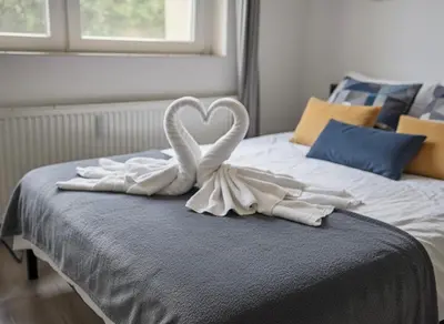 a bed with two swans forming a heart on it at NEW beautiful apartment 15 minutes from the city center in Prague