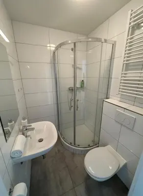 a bathroom with a shower and a toilet and a sink at NEW beautiful apartment 15 minutes from the city center in Prague