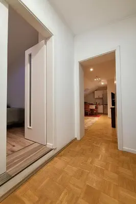 an open door in a room with a wooden floor at KindStay Suite w Free Parking near Prague Airport in Tuchoměřice