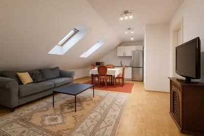 a living room with a couch and a table at KindStay Suite w Free Parking near Prague Airport in Tuchoměřice