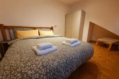a bedroom with a bed with two towels on it at KindStay Suite w Free Parking near Prague Airport in Tuchoměřice