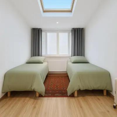two beds in a room with a window at KindStay Suite w Free Parking near Prague Airport in Tuchoměřice