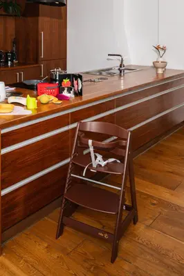a chair sitting in front of a kitchen counter at Prague Days - Family Two-Bedroom Apartment with, AC, and sound system in Vinohrady in Prague