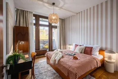 a bedroom with a bed and a desk and a window at Prague Days - Family Two-Bedroom Apartment with, AC, and sound system in Vinohrady in Prague