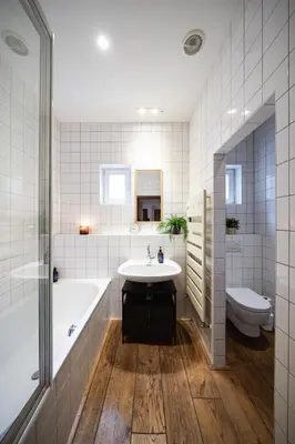 a bathroom with a tub and a sink and a toilet at Prague Days - Family Two-Bedroom Apartment with, AC, and sound system in Vinohrady in Prague