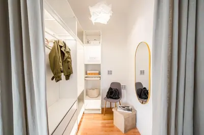 a dressing room with a mirror and a surfboard on the wall at Prague Days - One-Bedroom Apartment with Sauna, AC and Workspace in Žižkov in Prague