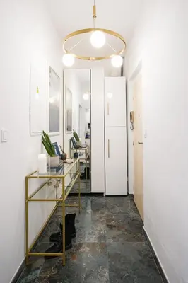 an office with a glass desk and a hallway at Prague Days - One-Bedroom Apartment with Sauna, AC and Workspace in Žižkov in Prague