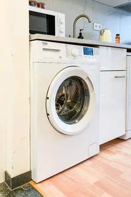 a white washer and dryer in a kitchen at Prague Days - One-Bedroom Apartment with Sauna, AC and Workspace in Žižkov in Prague