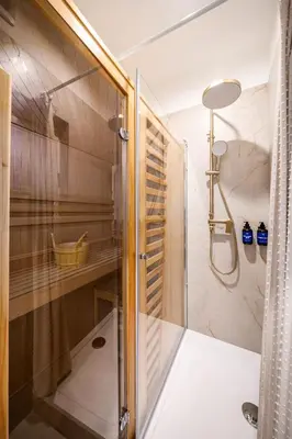 a shower with a glass door in a bathroom at Prague Days - One-Bedroom Apartment with Sauna, AC and Workspace in Žižkov in Prague