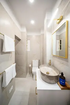 a bathroom with a large sink and a toilet at Prague Days - One-Bedroom Apartment with Sauna, AC and Workspace in Žižkov in Prague