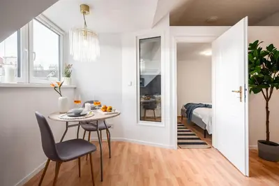 a small dining room with a table and chairs at Prague Days - One-Bedroom Apartment with Sauna, AC and Workspace in Žižkov in Prague