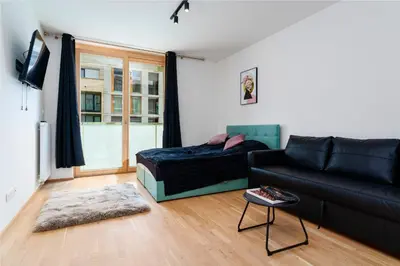 a living room with a couch and a bed at Timeless Elegance Suite in Prague