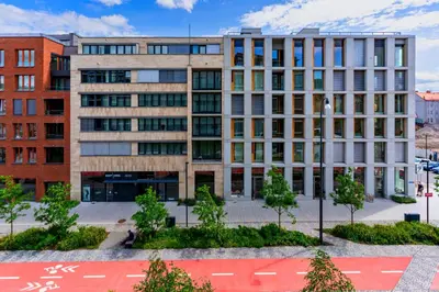 an office building with trees in front of it at Timeless Elegance Suite in Prague