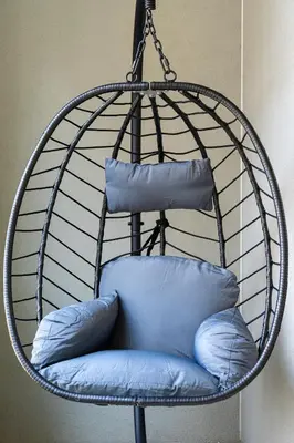 a hanging chair with blue pillows in it at Timeless Elegance Suite in Prague