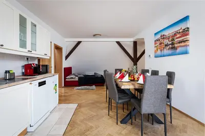 a kitchen and dining room with a table and chairs at Royal Skyline Penthouse in Prague