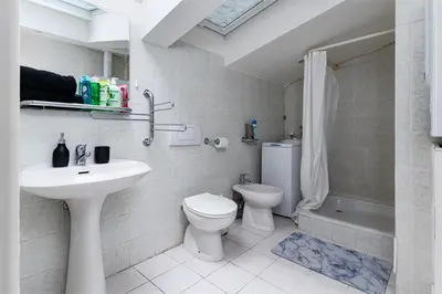 a bathroom with a sink and a toilet and a shower at Royal Skyline Penthouse in Prague