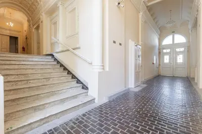an empty hallway with stairs in a building at Newly renovated flat with a loft in Prague