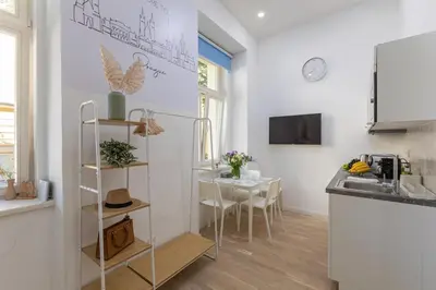 a kitchen and dining room with a table at Newly renovated flat with a loft in Prague