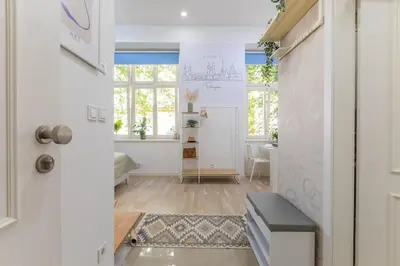 a hallway with white walls and a door with a window at Newly renovated flat with a loft in Prague