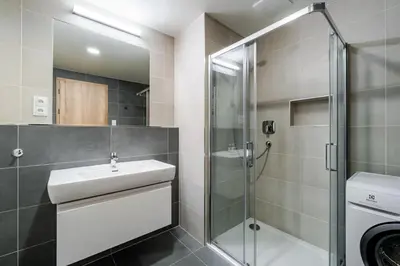 a kitchen with white cabinets and a sink at Blueground Prague 7 furnished close to offices PRG-12 in Prague