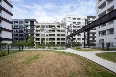 a large apartment building with a grassy yard in front of it at Blueground Prague 7 furnished close to offices PRG-12 in Prague
