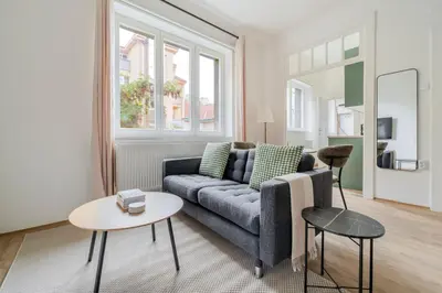 a living room with a couch and a table at Blueground Anděl view nr Vltava River PRG-80 in Prague