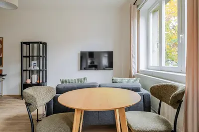 a living room with a couch and a table at Blueground Anděl view nr Vltava River PRG-80 in Prague