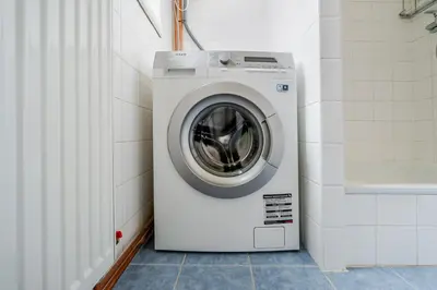 a washing machine in a bathroom next to a wall at Blueground Anděl view nr Vltava River PRG-80 in Prague