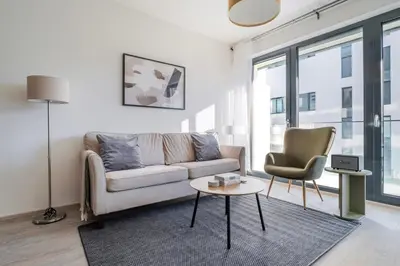 a living room with a couch and a table and a chair at Blueground Žižkov balcony nr Vítkov Hill PRG-82 in Prague