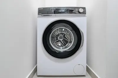 a white washing machine in a white room at Blueground Žižkov balcony nr Vítkov Hill PRG-82 in Prague