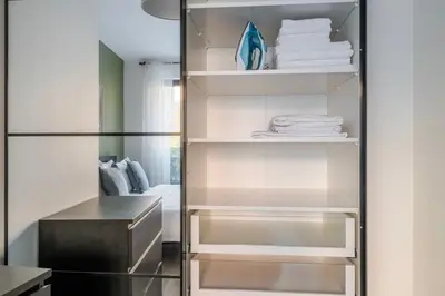 a walk in closet with white towels on shelves at Blueground Žižkov balcony nr Vítkov Hill PRG-82 in Prague