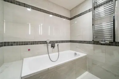 a bathroom with a bath tub and a shower at Blueground Žižkov balcony nr Vítkov Hill PRG-82 in Prague