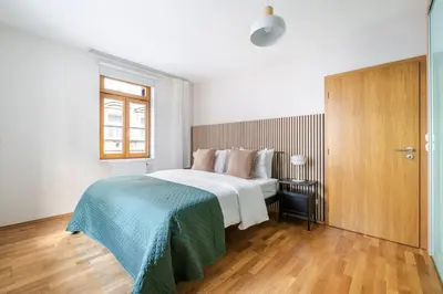 a bedroom with a large white bed and a window at Blueground Vršovice view nr Havlíčkovy sady PRG-81 in Prague