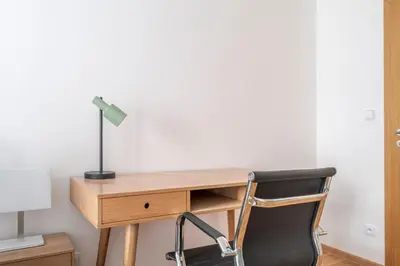 a desk with a lamp and a chair at Blueground Vršovice view nr Havlíčkovy sady PRG-81 in Prague