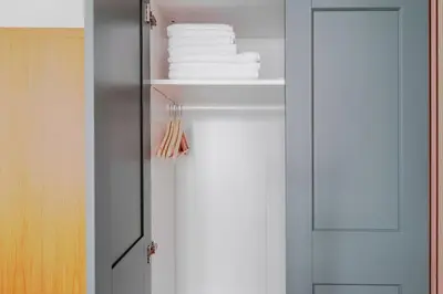 a closet with white towels on a shelf at Blueground Vršovice view nr Havlíčkovy sady PRG-81 in Prague