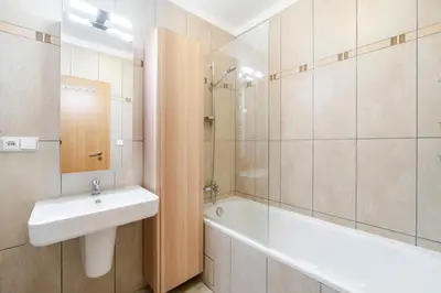 a bathroom with a sink and a shower and a bath tub at Blueground Vršovice view nr Havlíčkovy sady PRG-81 in Prague