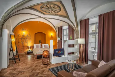 a bedroom with a bed and a tv in a room at 7 Tales Apartments by Adrez in Prague