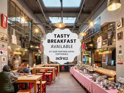 a restaurant with tables and a sign that reads tasty breakfast available at 7 Tales Apartments by Adrez in Prague