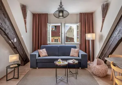 a living room with a blue couch and a table at 7 Tales Apartments by Adrez in Prague