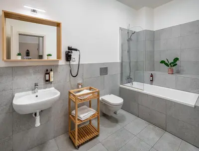 a bathroom with a sink and a toilet and a tub at 7 Tales Apartments by Adrez in Prague