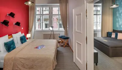 a hotel room with a bed and a window at 7 Tales Apartments by Adrez in Prague